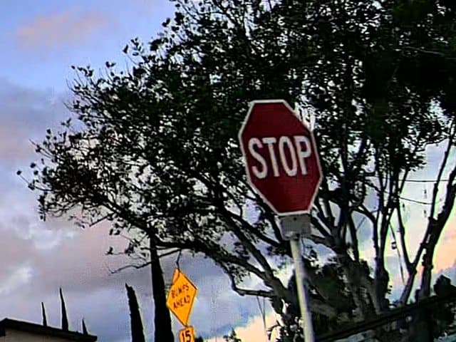 Dashcam frame from a pilot corridor with a detected stop sign